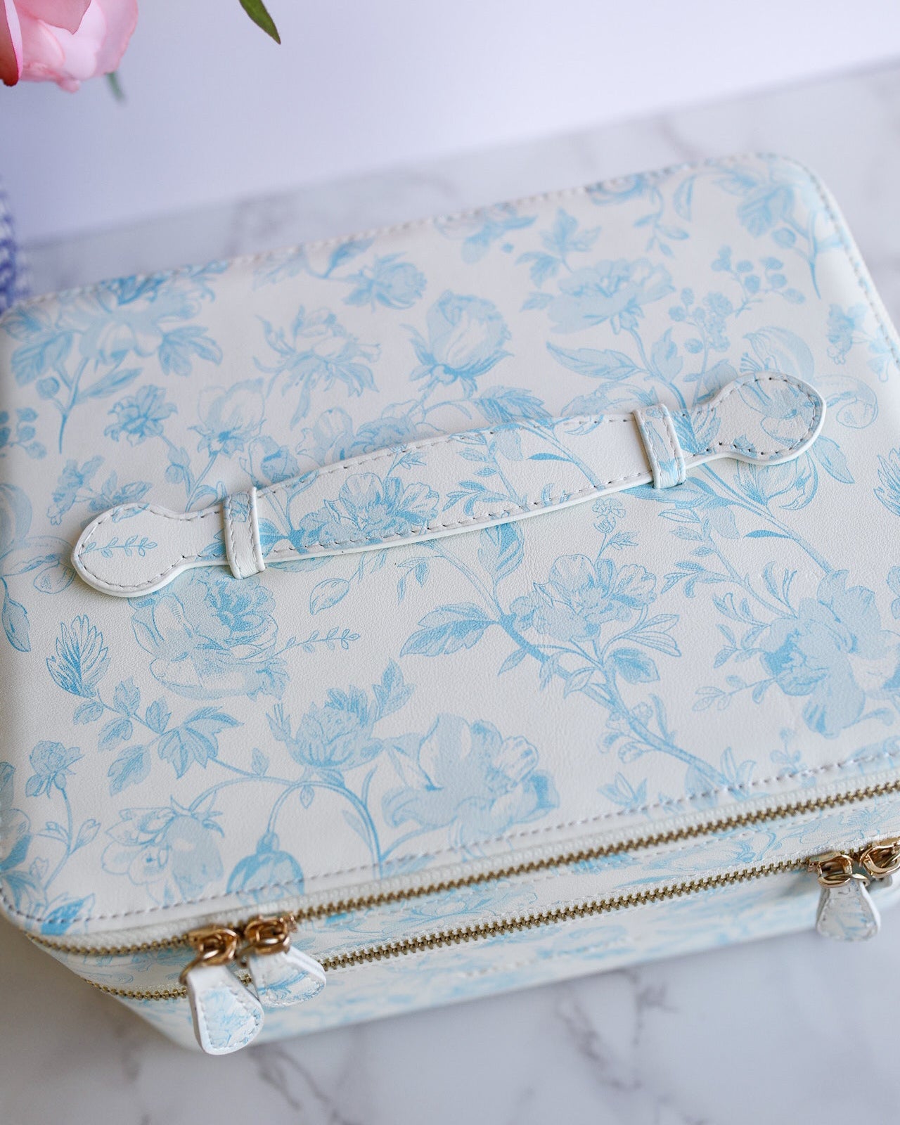 Floral-patterned suitcase with a floral background